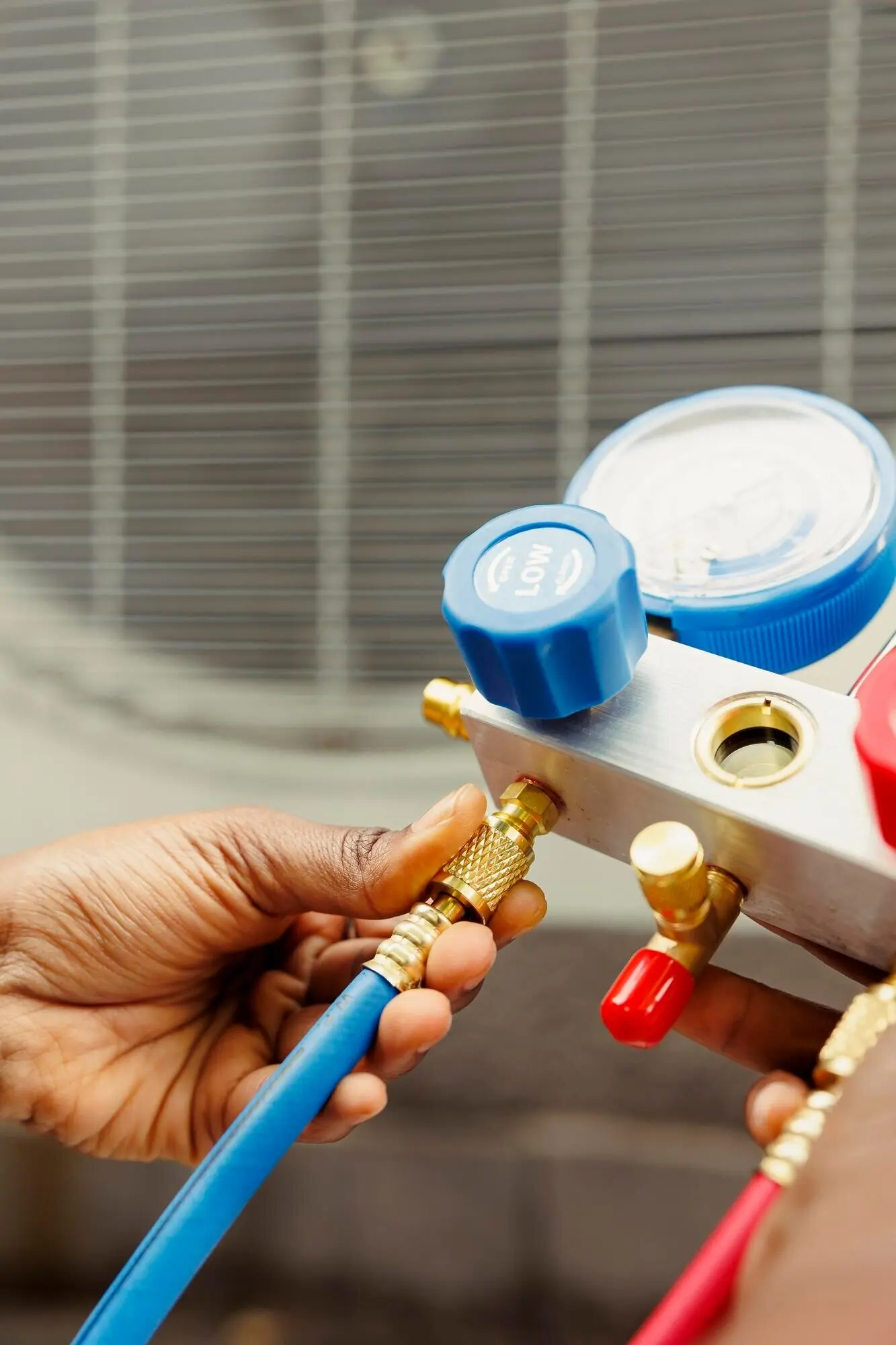 Close-up of a worker inspecting a freon tank